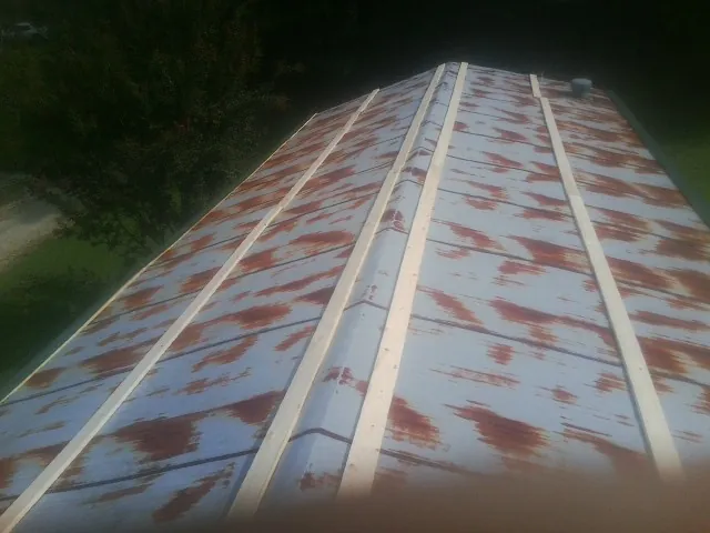 Rusted metal roof panels with new wood purlins before replacement — Storm Damage Roof Repair in Pinopolis by Roofing Brothers
